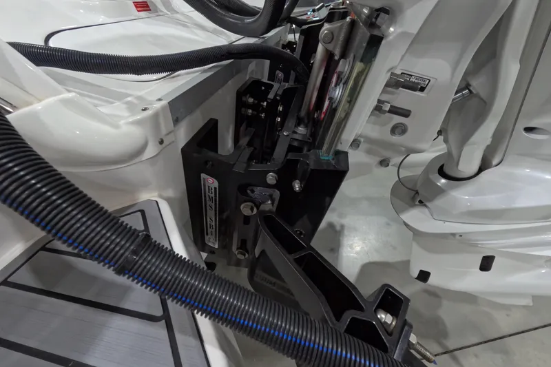 Slide: The Image of 2024 Tidewater boat engine compartment with mechanical components and wiring. - 6