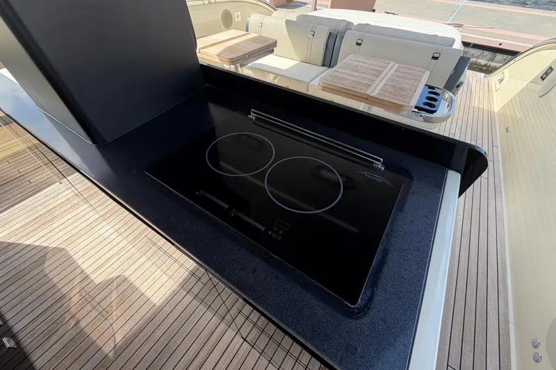 Slide: The Image of Outdoor kitchen on 2024 Invictus TT460 yacht with sleek induction cooktop. - 14