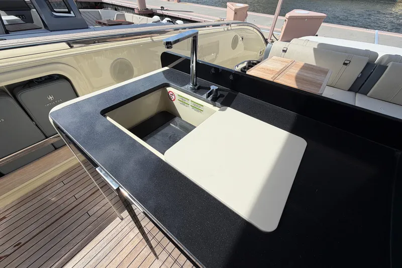 Slide: The Image of 2024 Invictus TT460 yacht kitchen sink with sleek black countertop and modern faucet. - 16