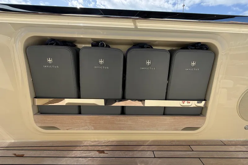 Slide: The Image of Storage compartment on 2024 Invictus TT460 yacht with branded bags and wooden flooring. - 17