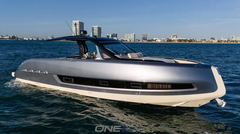 Slide: The Image of 2024 Invictus TT460 luxury yacht cruising on the ocean near a city skyline. - 2