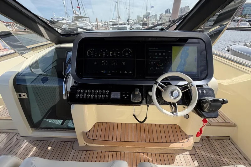 Slide: The Image of 2024 Invictus TT460 yacht helm with advanced navigation controls and sleek design. - 20