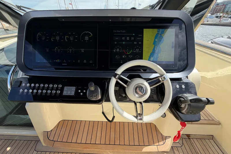 Slide: The Image of 2024 Invictus TT460 yacht helm with advanced navigation displays and controls. - 21