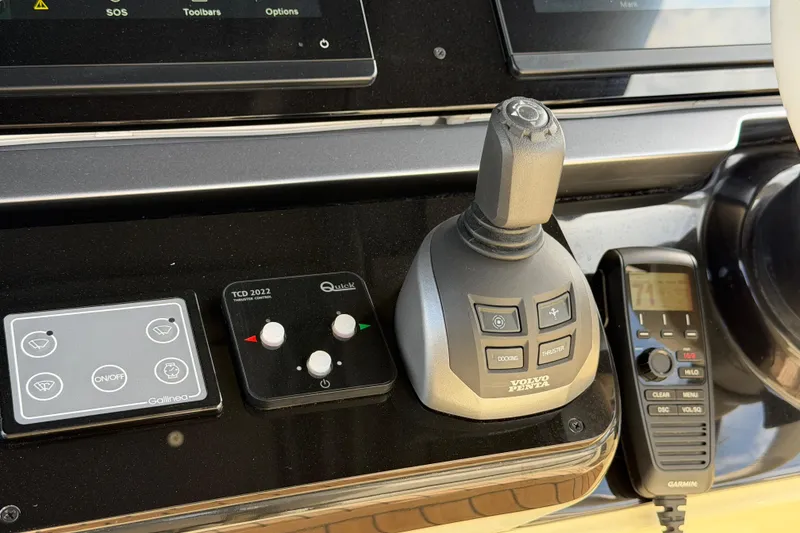 Slide: The Image of Control panel of 2024 Invictus TT460 yacht featuring joystick and communication device. - 23
