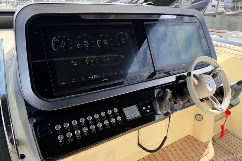 Slide: The Image of 2024 Invictus TT460 yacht helm with advanced navigation displays and controls. - 24