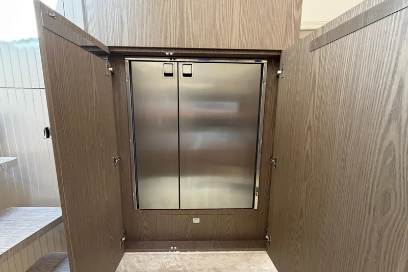 Slide: The Image of 2024 Invictus TT460 yacht interior with stainless steel double-door cabinet. - 30