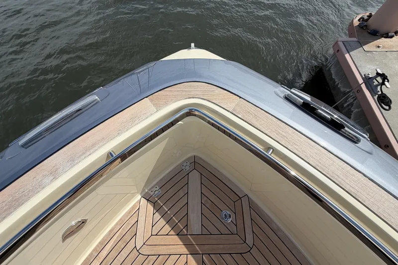 Slide: The Image of Bow view of 2024 Invictus TT460 yacht with sleek design and wooden deck. - 33