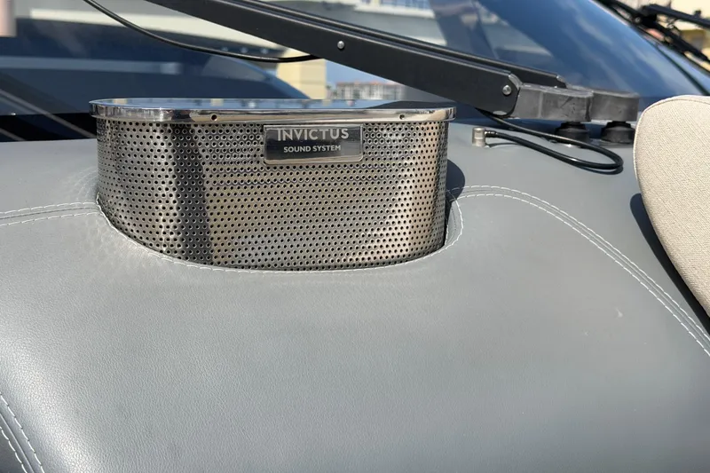 Slide: The Image of 2024 Invictus TT460 sound system detail on luxury boat dashboard. - 35