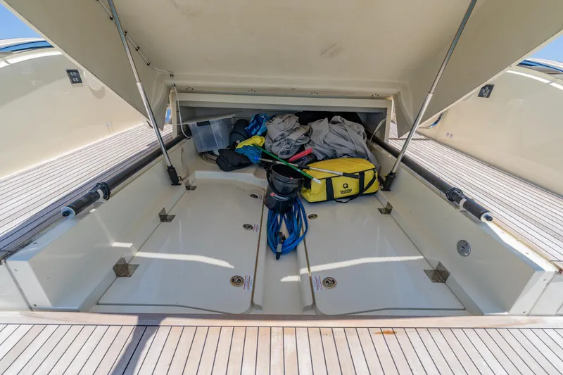 Slide: The Image of Open storage compartment on 2024 Invictus TT460 yacht deck with gear and equipment. - 55