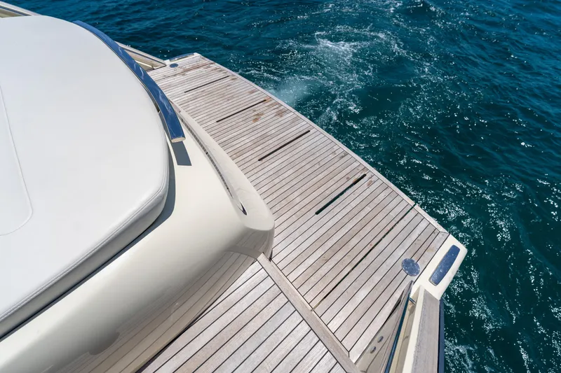 Slide: The Image of 2024 Invictus TT460 yacht deck overlooking blue ocean waters. - 56