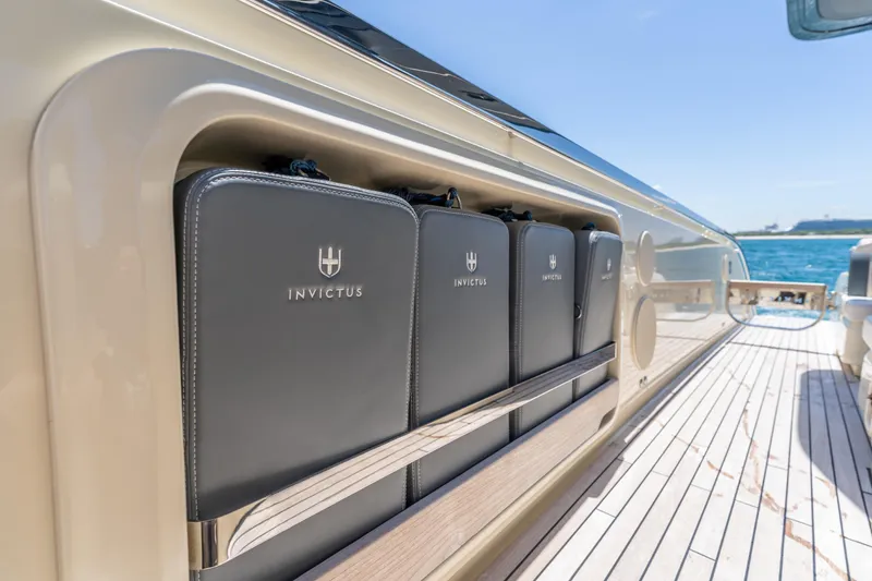 Slide: The Image of 2024 Invictus TT460 yacht deck with branded storage compartments. - 58
