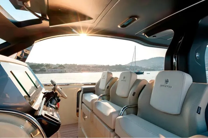 Slide: The Image of 2024 Invictus TT460 luxury yacht with spacious deck and modern design at marina. - 6
