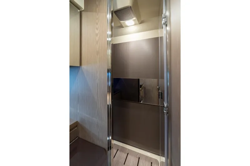 Slide: The Image of Interior of 2024 Invictus TT460 yacht, featuring sleek modern design and wood paneling. - 71