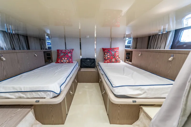 Slide: The Image of Luxurious twin cabin interior of 2024 Invictus TT460 yacht with modern design and vibrant pillows. - 76