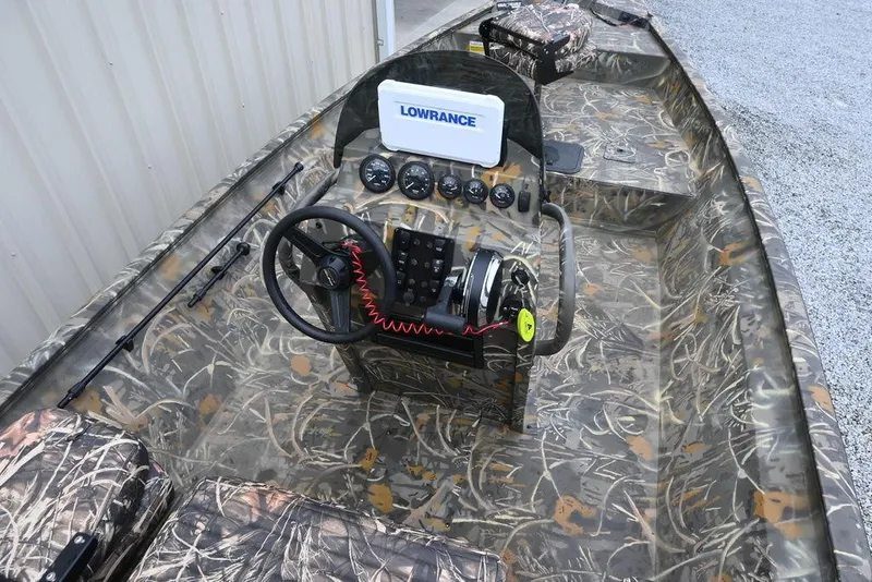 Slide: The Image of 2023 War Eagle 961 Blackhawk boat interior with camo design and Lowrance electronics. - 8