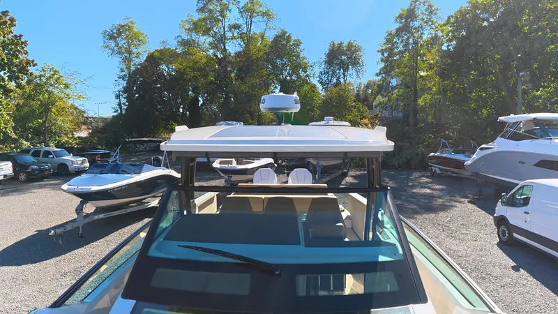 Slide: The Image of The image shows a 2027 Saxdor 320 GTO boat parked in an outdoor area with other boats. - 40