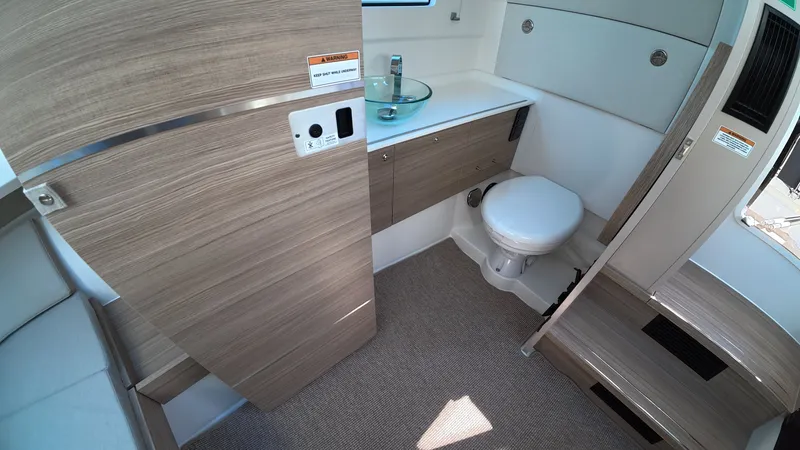 Slide: The Image of Interior of the 2027 Saxdor 320 GTO featuring a modern bathroom with wood paneling. - 28