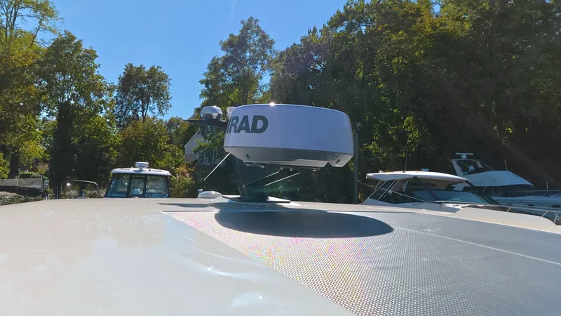 Slide: The Image of A 2027 Saxdor 320 GTO with a radar device on the roof, surrounded by trees. - 39