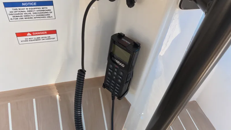 Slide: The Image of A radio is mounted on a boat's wall, with warning notices beside it. - 20