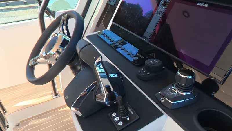 Slide: The Image of Helm of the Saxdor 320 GTO with modern instruments and wood deck. - 19
