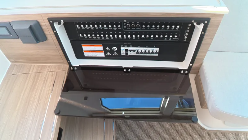 Slide: The Image of Electrical panel on a Saxdor 320 GTO boat, featuring switches and warning labels. - 24