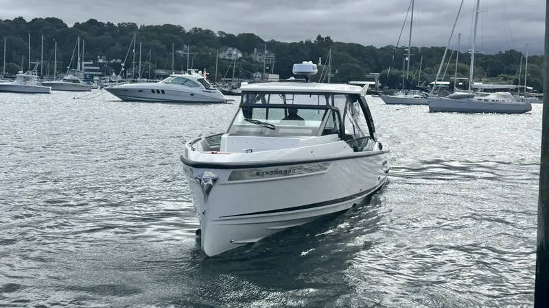 Slide: The Image of Saxdor 320 GTO 2027 on calm water with marina in the background. - 43