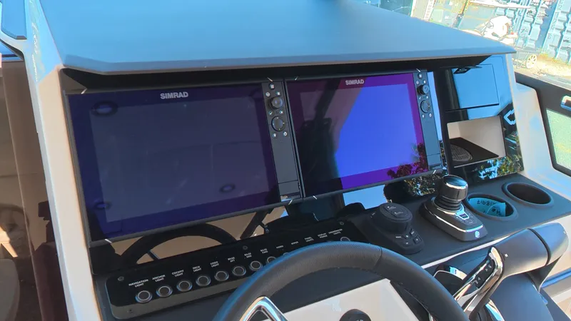 Slide: The Image of The image shows the cockpit of a 2027 Saxdor 320 GTO with modern Simrad displays and controls. - 17