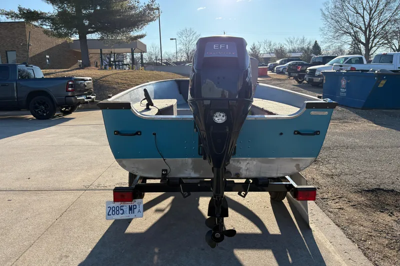 Slide: The Image of 1995 Lund 1440-V Rebel Tiller boat on trailer, parked outdoors, rear view. - 3