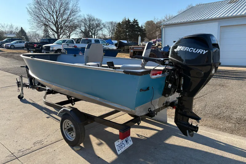 Slide: The Image of 1995 Lund 1440-V Rebel Tiller boat with Mercury engine on trailer. - 4