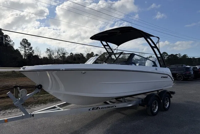 The Image of 2026 Stingray 20 SBX boat on trailer under cloudy sky. - 1