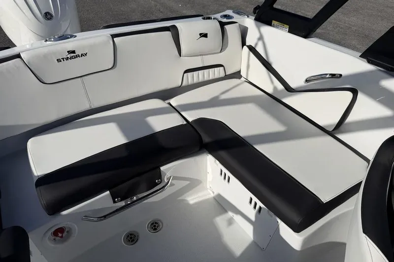 Slide: The Image of 2026 Stingray 20 SBX boat interior with sleek black and white seating design. - 13