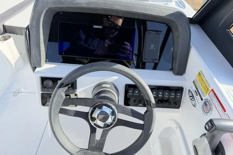Slide: The Image of 2026 Stingray 20 SBX boat dashboard with steering wheel and control panel. - 14