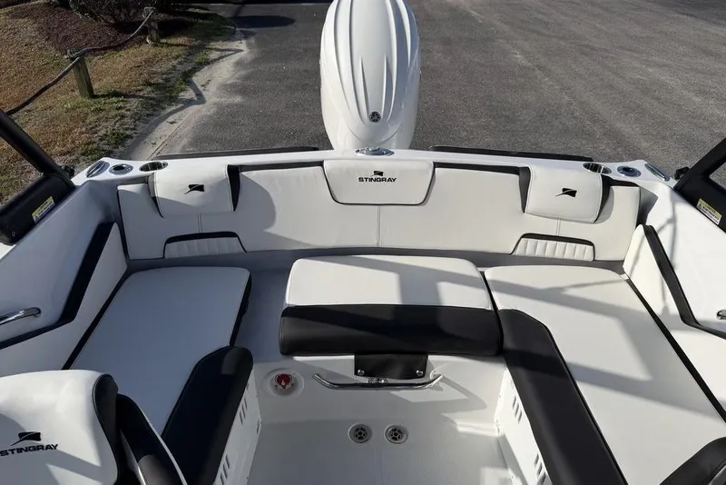 Slide: The Image of 2026 Stingray 20 SBX boat interior with white and black seating, cup holders, and sleek design. - 16