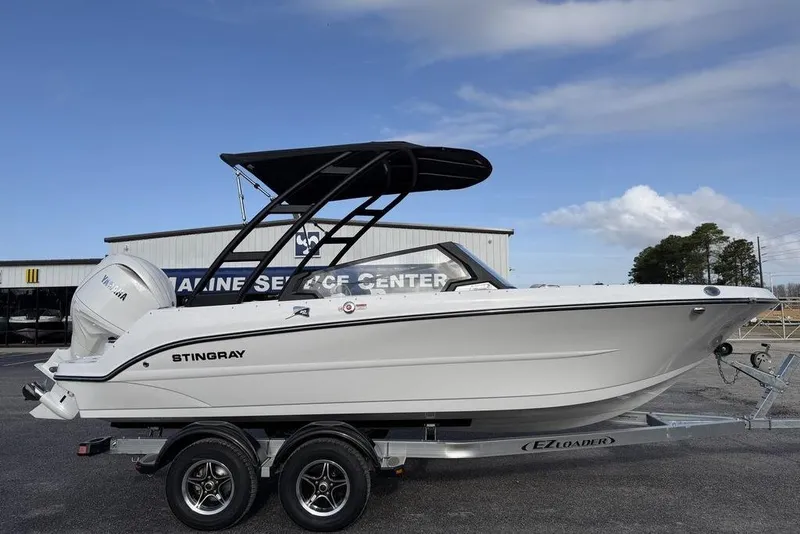 Slide: The Image of 2026 Stingray 20 SBX boat on trailer at marine service center. - 3