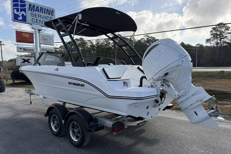 Slide: The Image of 2026 Stingray 20 SBX boat on trailer at marine service center. - 4