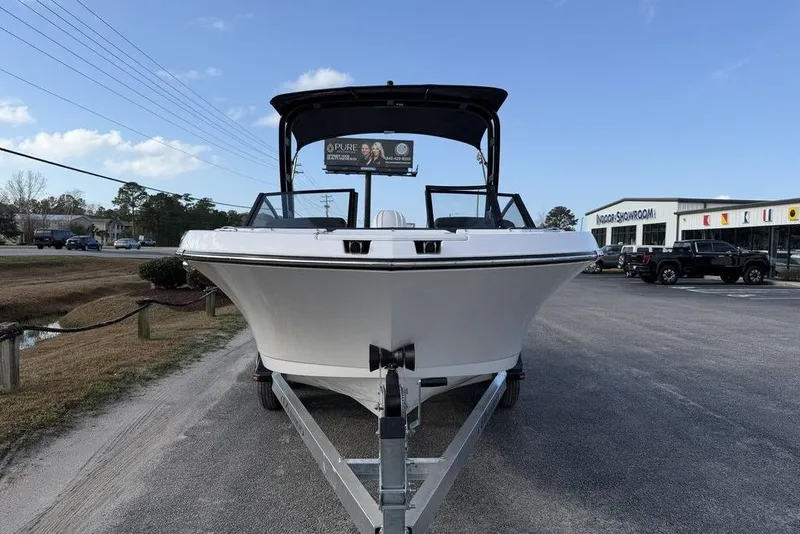 Slide: The Image of 2026 Stingray 20 SBX boat on trailer, outdoor showroom, clear sky. - 5
