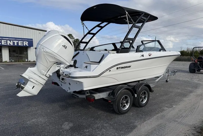 Slide: The Image of 2026 Stingray 20 SBX boat with Yamaha outboard motor on trailer in parking lot. - 6