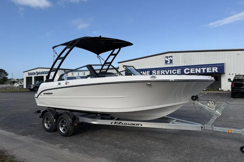 Slide: The Image of 2026 Stingray 20 SBX boat on trailer outside service center. - 7