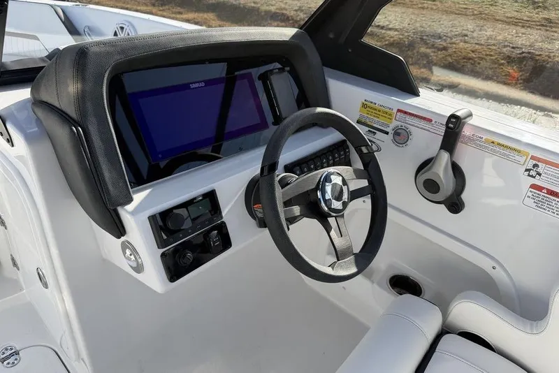 Slide: The Image of 2026 Stingray 20 SBX boat dashboard with steering wheel and control panel. - 9