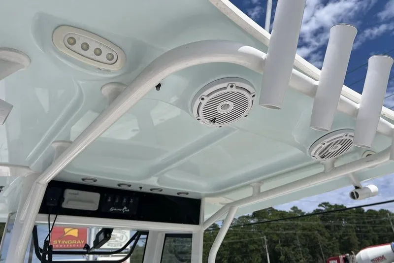 Slide: The Image of T-top of 2026 Sea Hunt Gamefish 25 boat with speakers and rod holders. - 14