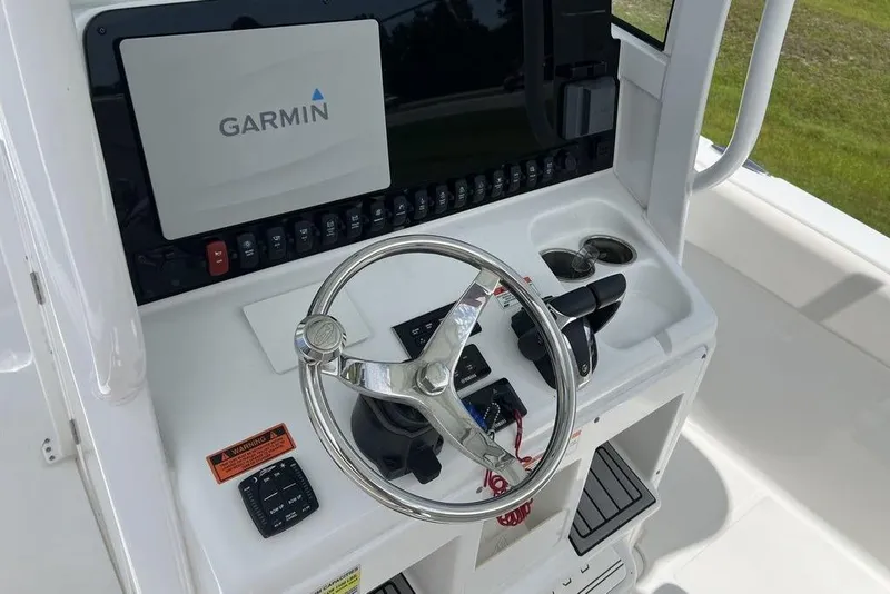 Slide: The Image of 2026 Sea Hunt Gamefish 25 helm with Garmin display and steering wheel. - 17