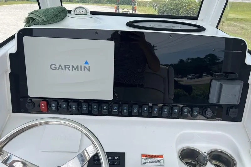 Slide: The Image of Helm of 2026 Sea Hunt Gamefish 25 with Garmin navigation system and control panel. - 19