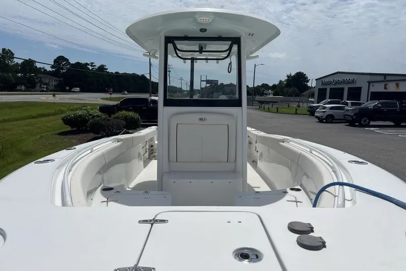 Slide: The Image of 2026 Sea Hunt Gamefish 25 boat displayed outdoors near a showroom. - 24