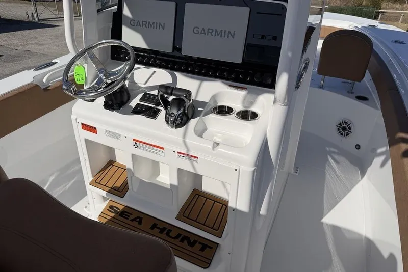 Slide: The Image of 2026 Sea Hunt Gamefish 27 boat console with Garmin displays and steering wheel. - 14