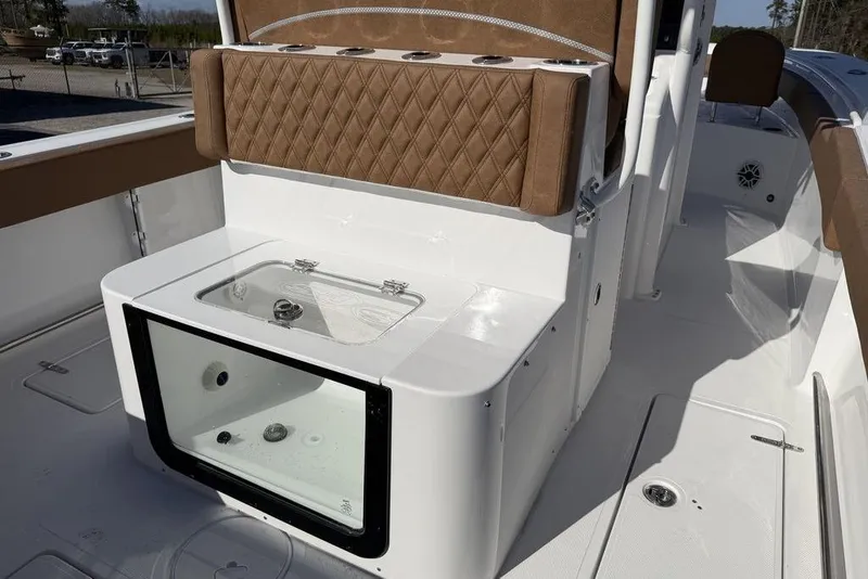 Slide: The Image of 2026 Sea Hunt Gamefish 27 boat interior with cushioned seating and storage compartment. - 15