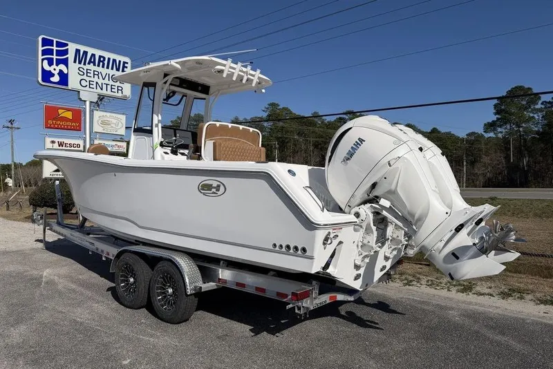 Slide: The Image of 2026 Sea Hunt Gamefish 27 boat on trailer at marine service center. - 5
