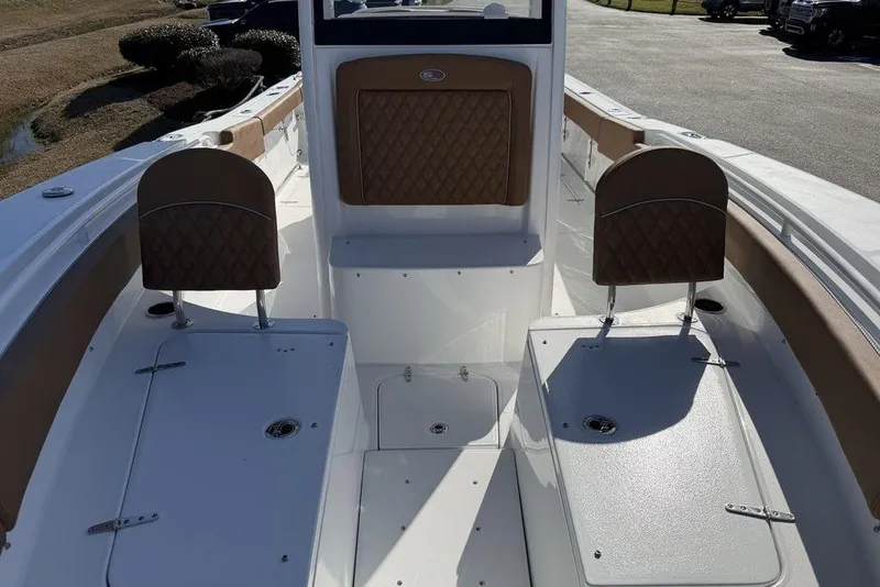 Slide: The Image of 2026 Sea Hunt Gamefish 27 boat interior with cushioned seating and storage compartments. - 9