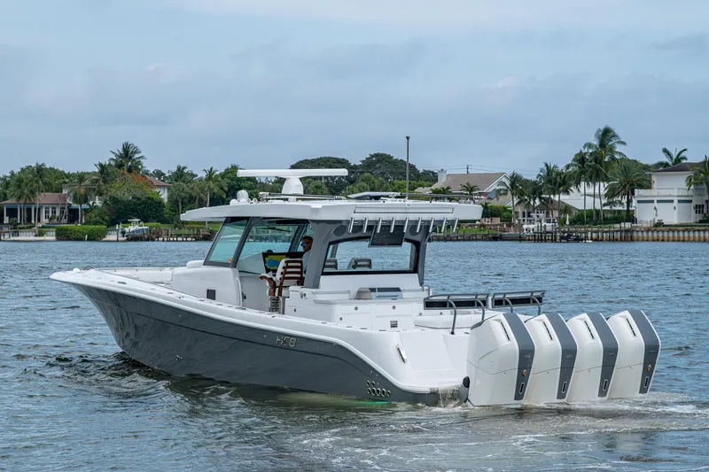 Slide: The Image of 2025 HCB 48 Campeon boat cruising on a scenic waterway. - 10