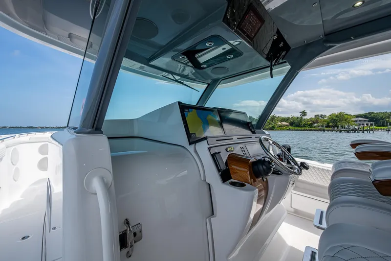 Slide: The Image of 2025 HCB 48 Campeon boat cockpit with modern navigation system and luxurious seating. - 25