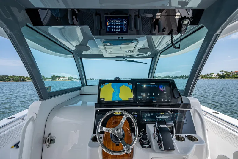 Slide: The Image of Helm of 2025 HCB 48 Campeon boat with advanced navigation displays and controls. - 26